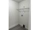 Bright laundry area with hookups, a shelf, and neutral walls and flooring at 2075 Dixie Ave, Sanford, FL 32771