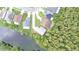 Aerial view of the home featuring water views and mature trees at 2262 Stonehedge Loop, Kissimmee, FL 34743