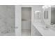 Bathroom featuring a marble tiled shower, quartz countertop, and a view of the second level at 2262 Stonehedge Loop, Kissimmee, FL 34743
