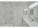 Bathroom showcases marble tile, a tub, and a vanity with an oval mirror at 2262 Stonehedge Loop, Kissimmee, FL 34743