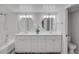 Bathroom featuring a double vanity with granite countertops, and a tub with marble-look shower walls at 2262 Stonehedge Loop, Kissimmee, FL 34743