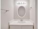 Modern bathroom vanity with oval mirror, updated lighting, and brushed nickel hardware at 2262 Stonehedge Loop, Kissimmee, FL 34743