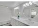 Bathroom featuring a double vanity with granite countertops, and a tub with marble-look shower walls at 2262 Stonehedge Loop, Kissimmee, FL 34743
