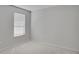 Clean, bright bedroom with neutral carpet and walls, featuring a window with blinds at 2262 Stonehedge Loop, Kissimmee, FL 34743