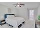 Bright bedroom with a queen-sized bed, ceiling fan, and neutral decor, leading to the en-suite bathroom at 2262 Stonehedge Loop, Kissimmee, FL 34743