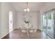 Dining area with a glass table, and sliding doors that offer an abundant view of the outdoor at 2262 Stonehedge Loop, Kissimmee, FL 34743