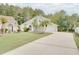 Charming home features a two-car garage, mature landscaping, and a well-manicured lawn at 2262 Stonehedge Loop, Kissimmee, FL 34743