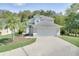 Attractive two-story home with attached two-car garage, well-kept lawn, and beautiful landscaping at 2262 Stonehedge Loop, Kissimmee, FL 34743