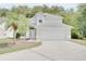 Two-story home featuring an attached two-car garage, neutral paint and meticulously maintained lawn at 2262 Stonehedge Loop, Kissimmee, FL 34743