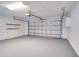 Clean, empty two car garage with white walls and shelving at 2262 Stonehedge Loop, Kissimmee, FL 34743