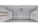 Clean, empty two car garage with white walls and shelving at 2262 Stonehedge Loop, Kissimmee, FL 34743