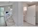 Hallway with staircase adjacent to a partial bathroom that features updated vanity and fixtures at 2262 Stonehedge Loop, Kissimmee, FL 34743