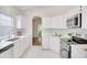 Bright kitchen features stainless steel appliances, white cabinetry, and ample counter space at 2262 Stonehedge Loop, Kissimmee, FL 34743