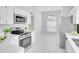 Bright kitchen featuring white cabinets, quartz countertops, and stainless steel appliances at 2262 Stonehedge Loop, Kissimmee, FL 34743