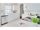 Bright kitchen with white cabinetry, stainless steel dishwasher and ample counter space at 2262 Stonehedge Loop, Kissimmee, FL 34743