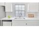 Well lit kitchen sink with white cabinets, quartz countertops, and stainless steel appliances at 2262 Stonehedge Loop, Kissimmee, FL 34743