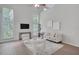 Bright living room featuring high ceilings, modern furnishings, and is naturally illuminated with large windows at 2262 Stonehedge Loop, Kissimmee, FL 34743