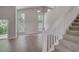 Bright living room with high ceilings, modern flooring, and staircase leading to the second level at 2262 Stonehedge Loop, Kissimmee, FL 34743