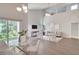 Bright living room with high ceilings, modern furnishings, and large windows overlooking a lush green yard at 2262 Stonehedge Loop, Kissimmee, FL 34743