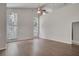 Bright living room featuring hardwood floors, neutral walls, and large windows for natural light at 2262 Stonehedge Loop, Kissimmee, FL 34743