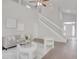 Bright, open living area with a staircase, comfortable seating, and neutral decor at 2262 Stonehedge Loop, Kissimmee, FL 34743
