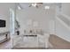 Bright living room features high ceilings, modern furnishings, and is naturally illuminated with large windows at 2262 Stonehedge Loop, Kissimmee, FL 34743
