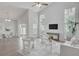 Open concept living space featuring vaulted ceiling, modern furnishings, and a view of the backyard at 2262 Stonehedge Loop, Kissimmee, FL 34743