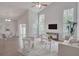 Open concept living space featuring vaulted ceiling, modern furnishings, and a view of the backyard at 2262 Stonehedge Loop, Kissimmee, FL 34743