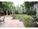 Private backyard with a large patio and lush greenery at 230 E Esther St, Orlando, FL 32806