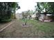Spacious backyard featuring a unique tree and lush greenery, creating a serene outdoor space at 230 E Esther St, Orlando, FL 32806
