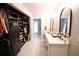 Elegant bathroom and closet space, featuring double sinks, closet, and modern fixtures at 230 E Esther St, Orlando, FL 32806