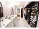 Elegant bathroom and closet space, featuring double sinks, closet, and modern fixtures at 230 E Esther St, Orlando, FL 32806