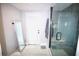 Bathroom with a modern glass shower, a sleek vanity mirror, and ample natural light at 230 E Esther St, Orlando, FL 32806