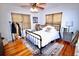Comfortable bedroom with wood floors and a ceiling fan at 230 E Esther St, Orlando, FL 32806