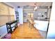 Bright kitchen with a convenient island, white cabinets, and an open view to the living room at 230 E Esther St, Orlando, FL 32806