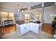 Open concept kitchen with a large island, white cabinetry, and seamless flow into the living area at 230 E Esther St, Orlando, FL 32806