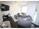 Comfortable living room featuring sleek tile flooring, a TV, and a stylish area rug at 230 E Esther St, Orlando, FL 32806