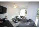Modern living room with a comfortable gray sofa, sleek black tile floors, and abundant natural light at 230 E Esther St, Orlando, FL 32806