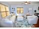 Bright living room with a plush sofa, stylish armchairs, and natural light streaming through the window at 230 E Esther St, Orlando, FL 32806