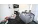 Well-lit living room with black tile floors, a comfortable gray sofa, and ample space for relaxation at 230 E Esther St, Orlando, FL 32806
