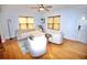 Inviting living room featuring hardwood floors, modern furniture, and a ceiling fan for added comfort at 230 E Esther St, Orlando, FL 32806