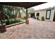 Inviting outdoor patio with beautiful brickwork, pergola, and surrounding greenery, perfect for relaxation at 230 E Esther St, Orlando, FL 32806