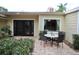 Inviting patio with elegant outdoor seating, and black-framed glass doors that create an inviting outdoor living space at 230 E Esther St, Orlando, FL 32806