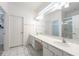 Bright bathroom with double sinks, a large mirror, and a separate shower area at 2613 Calistoga Ave, Kissimmee, FL 34741