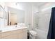 Well-lit bathroom with a shower/tub combo, white cabinets, and a neutral color scheme at 2613 Calistoga Ave, Kissimmee, FL 34741