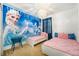 Charming ' bedroom with twin beds, featuring a Frozen-themed mural, and a whimsical chandelier at 2613 Calistoga Ave, Kissimmee, FL 34741