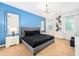 Inviting bedroom with a blue accent wall, bright windows, and stylish furnishings at 2613 Calistoga Ave, Kissimmee, FL 34741