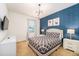 Stylish bedroom with a geometric accent wall, modern lighting, and coordinated furnishings for a chic look at 2613 Calistoga Ave, Kissimmee, FL 34741