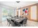 Elegant dining room with modern lighting, stylish decor, and sliding glass doors to the pool area at 2613 Calistoga Ave, Kissimmee, FL 34741