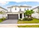 Charming two-story home featuring a two-car garage, lush landscaping, and a well-manicured lawn at 2613 Calistoga Ave, Kissimmee, FL 34741